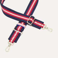 A close-up of The Crossbody Strap in Confetti Stripe, focusing on the end snap hooks and sliding buckle.