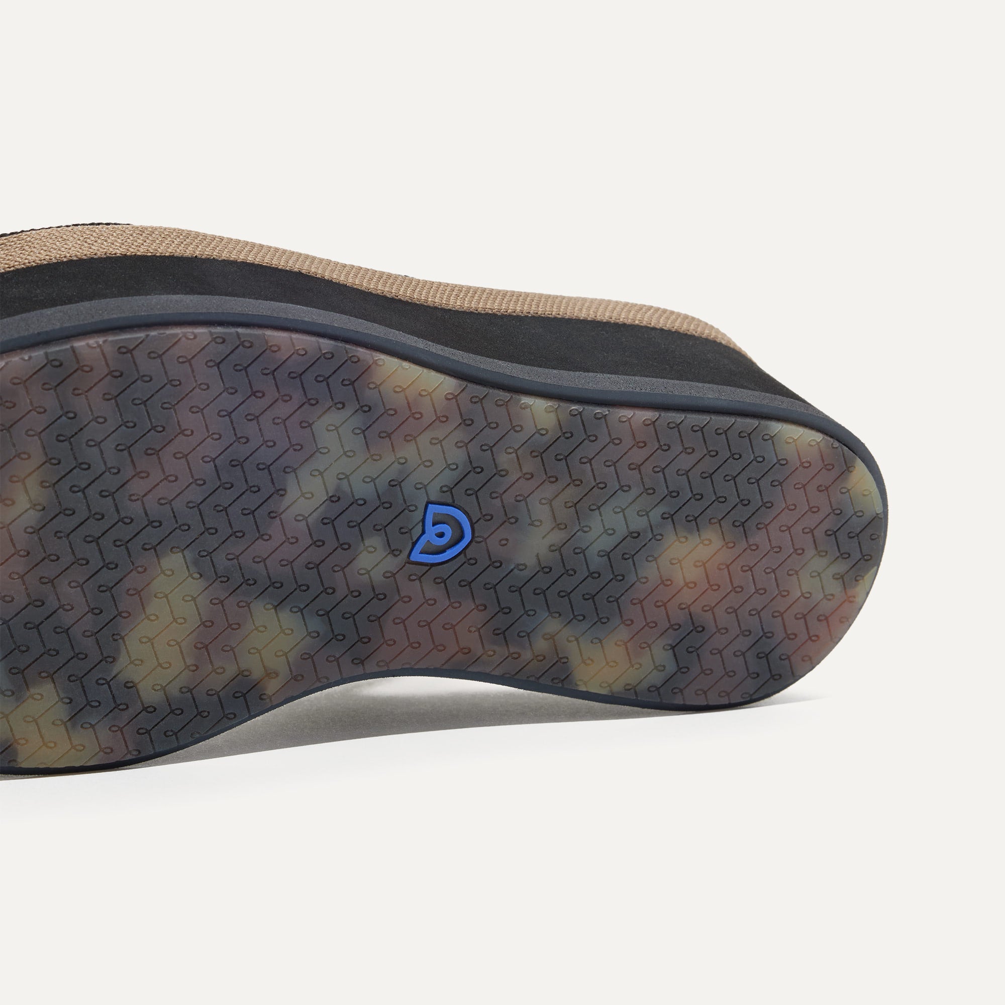 Close up of the outsole of The Lightweight Wedge Sandal in Pepper, shown in a diagonal view. 