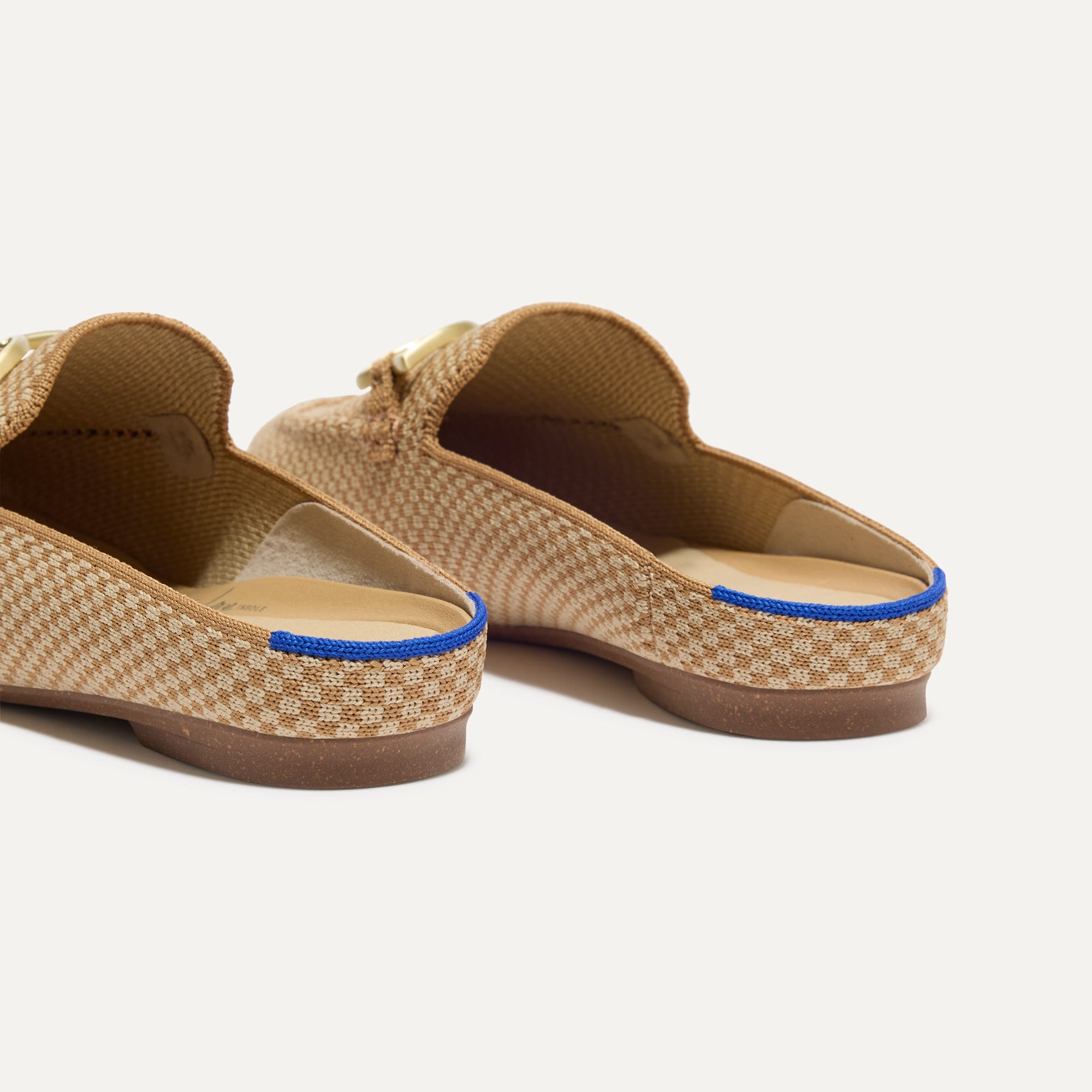 Close up of the heel of The Double Bit Loafer Mule in Waffle Micro Check, with Rothy's signature blue halo. 