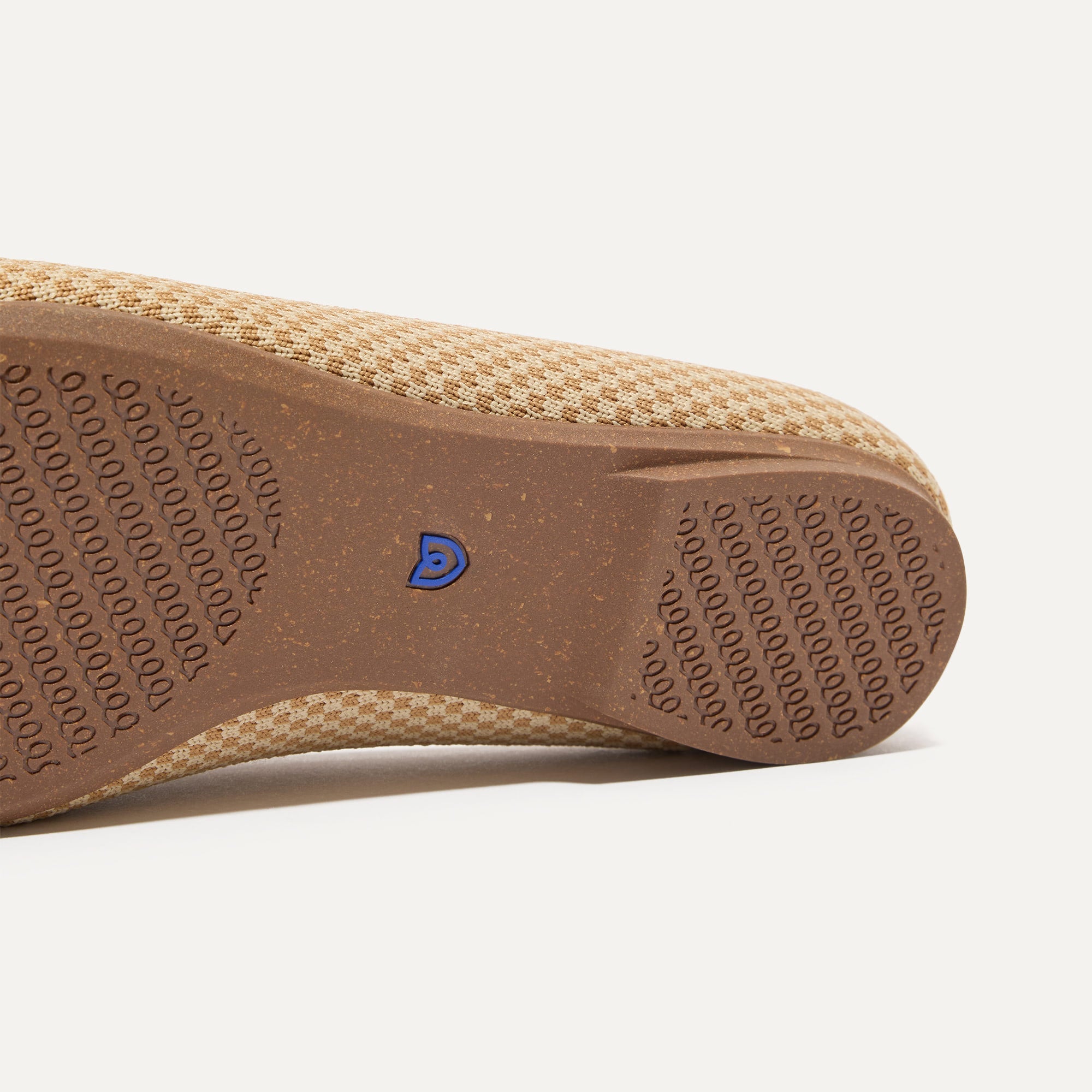 Close up of the outsoles of The Double Bit Loafer Mule in Waffle Micro Check.