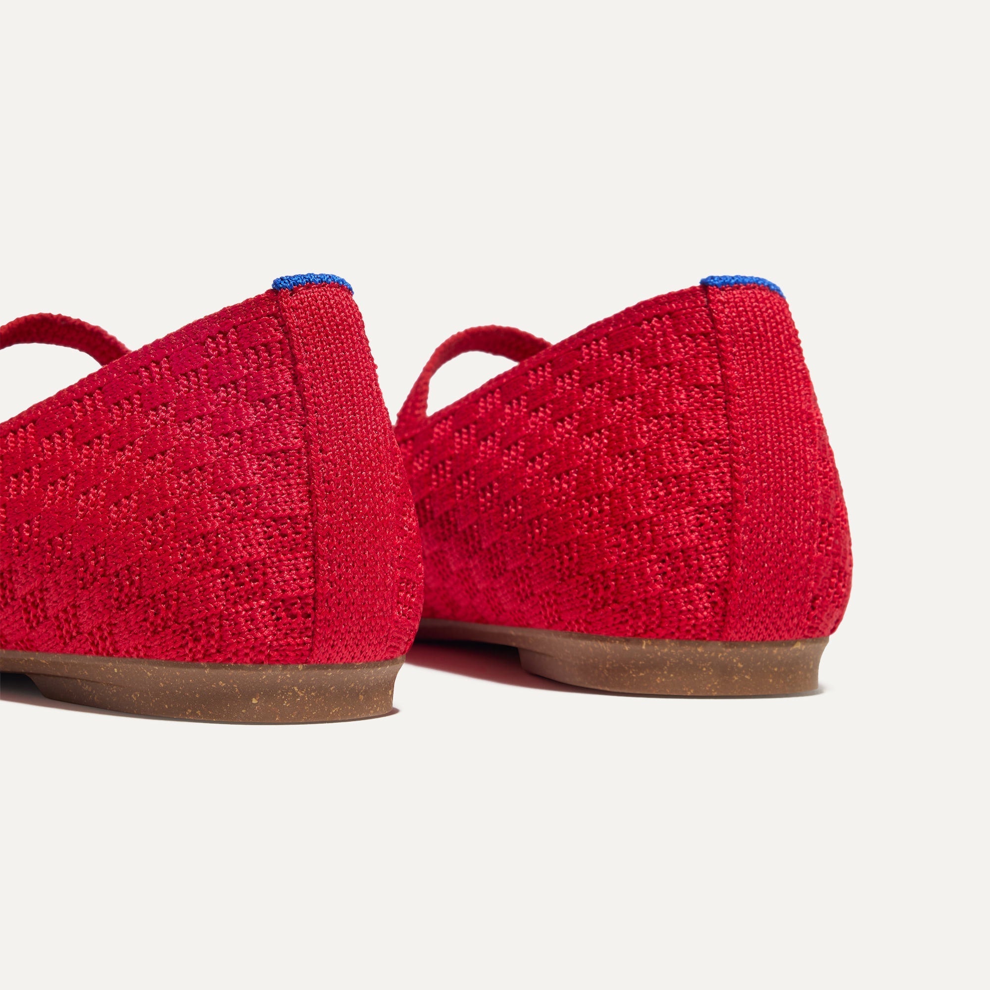 Close up of the heel of The Max Square Mary Jane in Red Crisp Basketweave, with Rothy's signature blue halo.