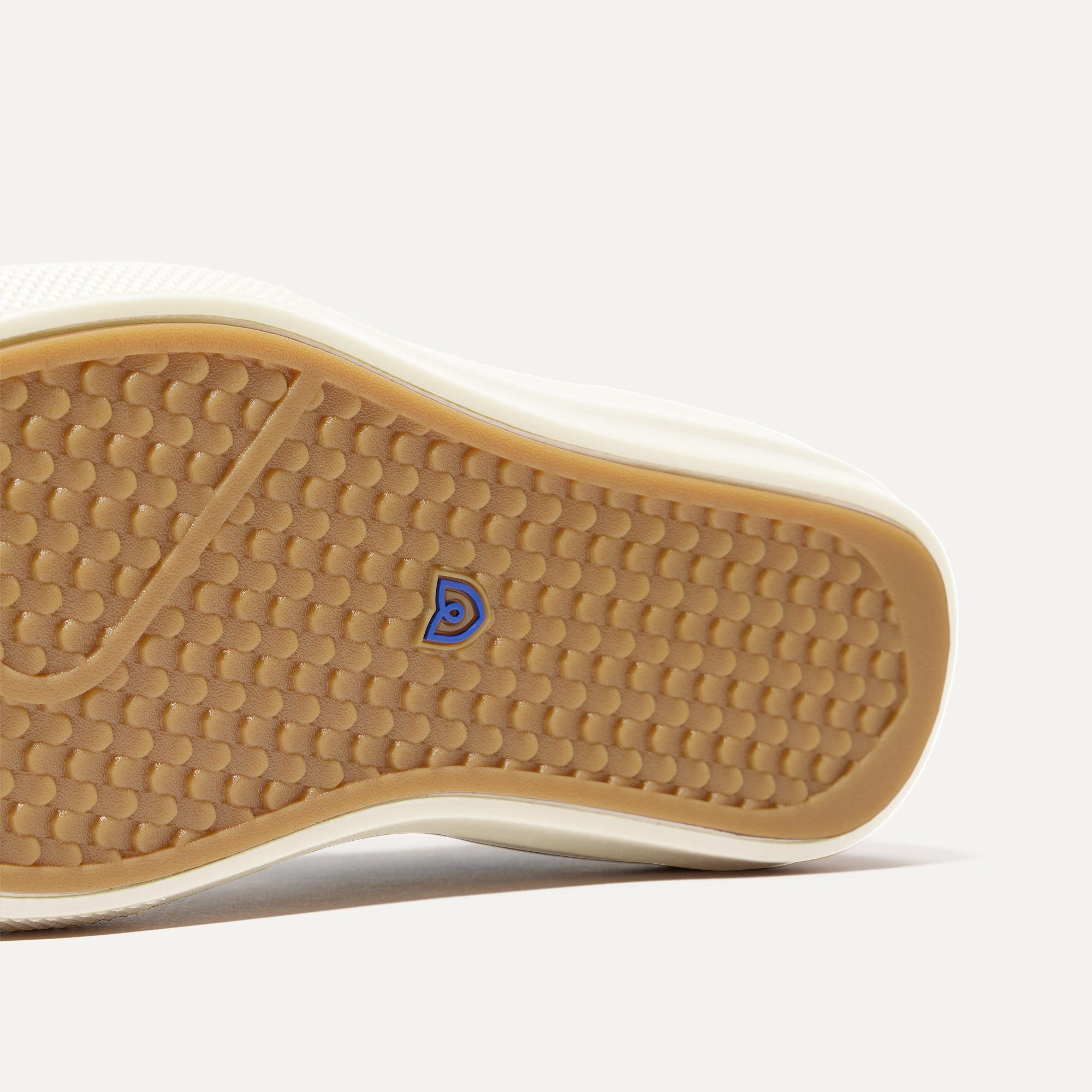 Close up of the outsoles of The RS02 Sneaker Burgundy Blitz, with raised grooves for added traction. 
